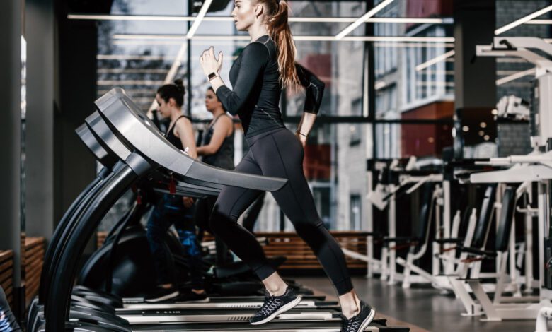 athletic girl dressed black sportswear running treadmill modern gym