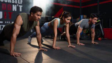 diverse group fit men woman sportswear exercise pushups floor fitness gym