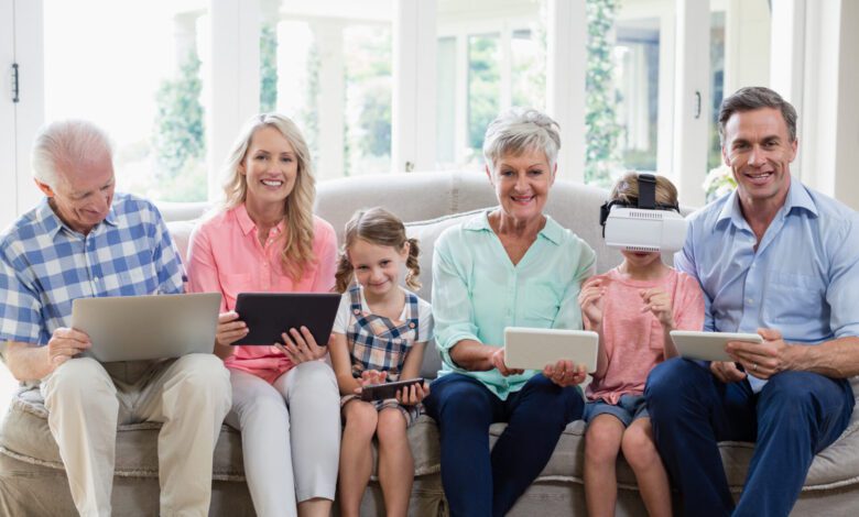 multi generation family using digital tablet mobile phone virtual headset living room