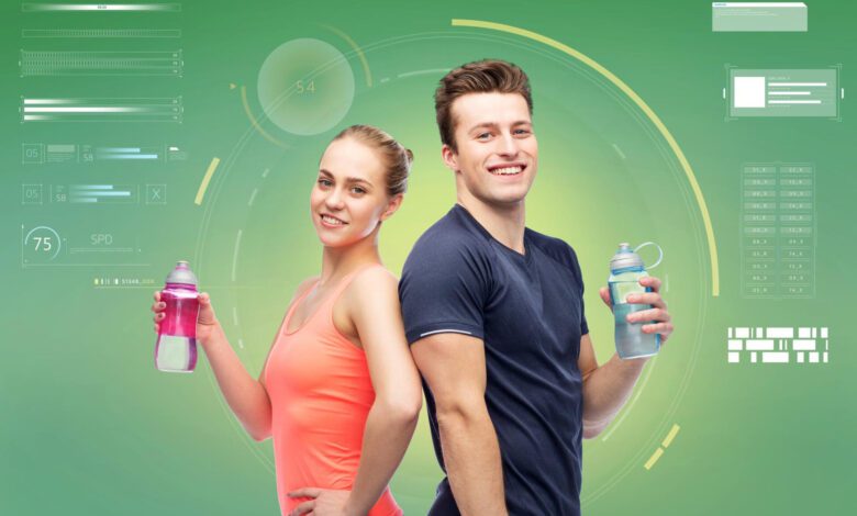 sport fitness technology people concept happy sportive man woman with water bottles green background