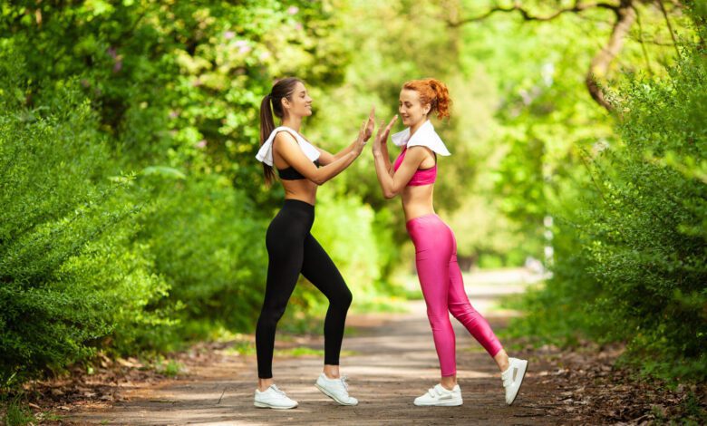 two women exercising park young beautiful woman doing exercises together outdoors