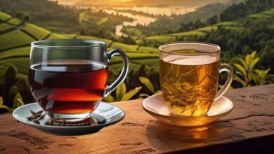 Black and green tea cups side by side with scattered tea leaves, illustrating their health benefits comparison