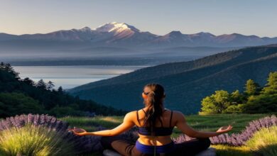 Person meditating on a grassy hill in a serene setting, representing the harmony of mind, body, and spirit