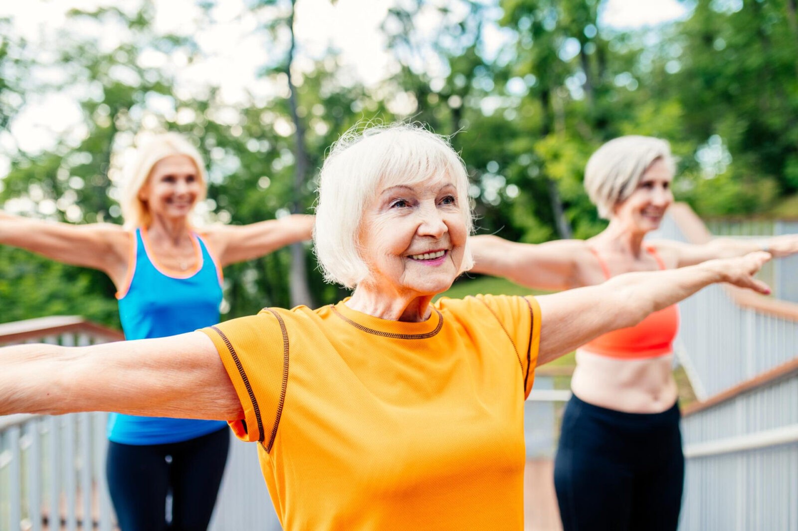 active senior women doing fitness park