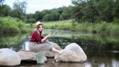 beautiful young girl nature by river with fishing rod