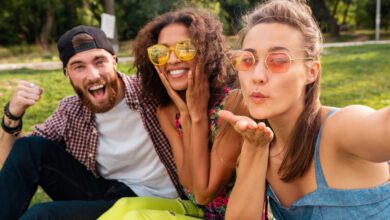 colorful stylish happy young company friends sitting park man women having fun together