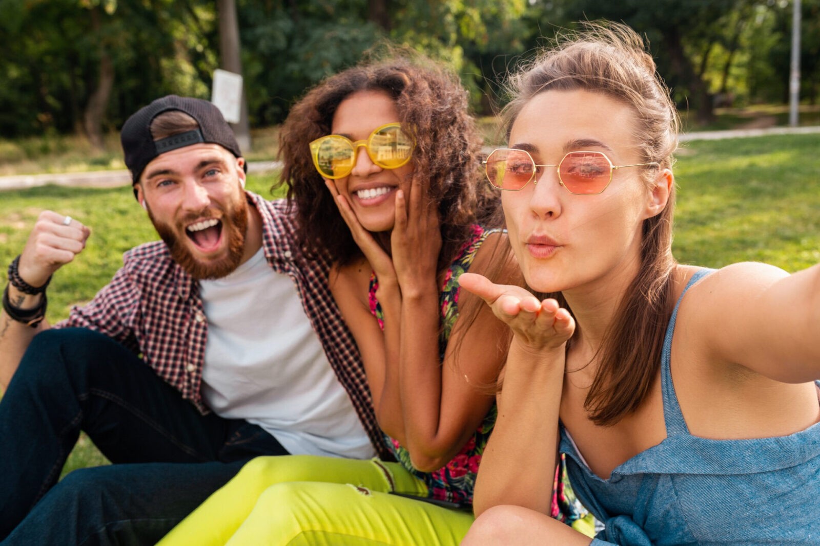 colorful stylish happy young company friends sitting park man women having fun together