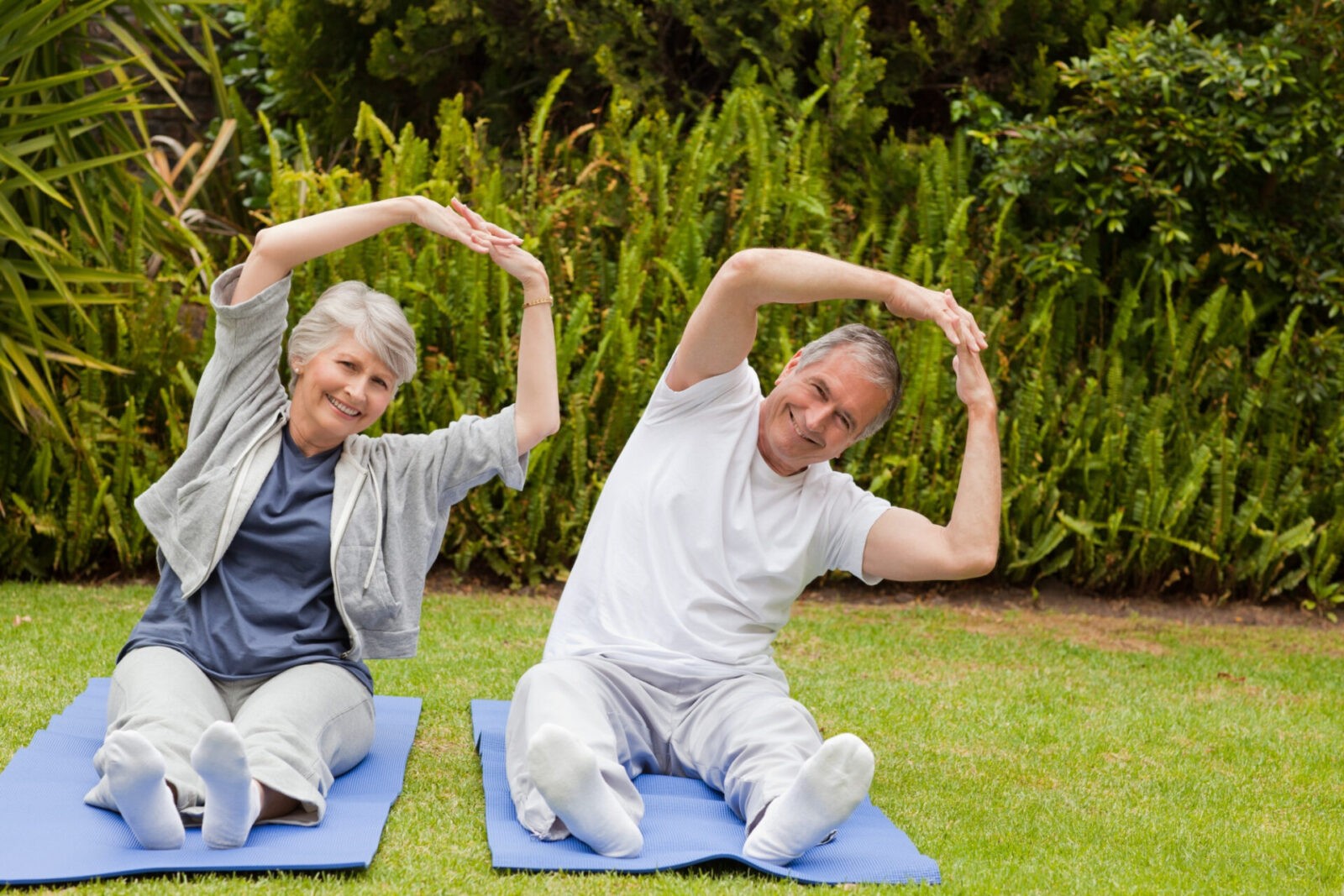 senior couple doing their streches garden