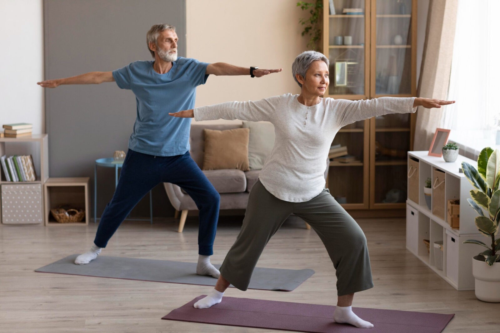 senior couple practicing yoga home