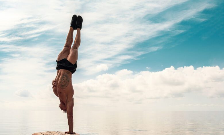 young man is doing street workout handstand exercise bodyweight