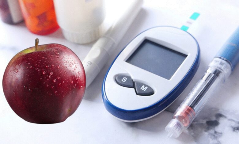 Apple next to glucose meter and insulin pen illustrating the connection between apples and diabetes management