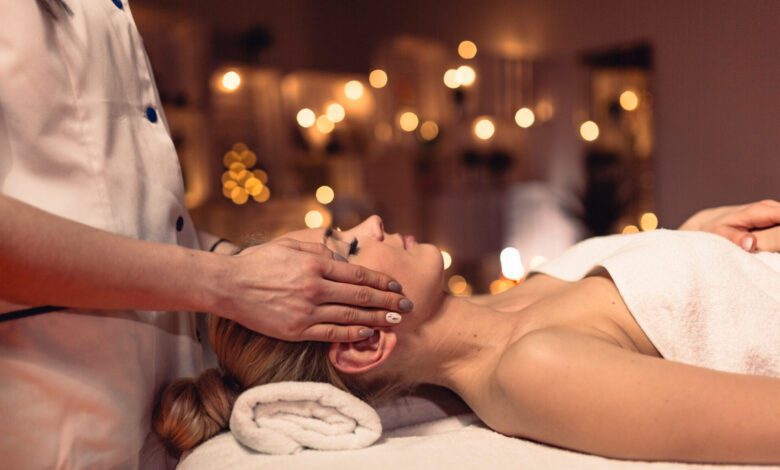 Woman receiving a therapeutic massage in a serene wellness salon setting.