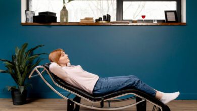 Woman relaxing comfortably in an ergonomic Stress Free Chair at home.