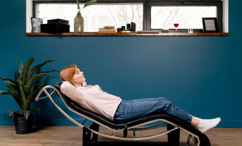 Woman relaxing comfortably in an ergonomic Stress Free Chair at home.