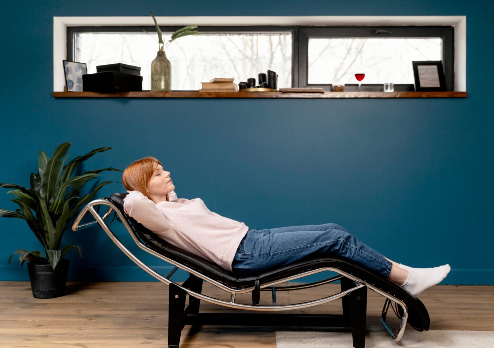 Woman relaxing comfortably in an ergonomic Stress Free Chair at home.