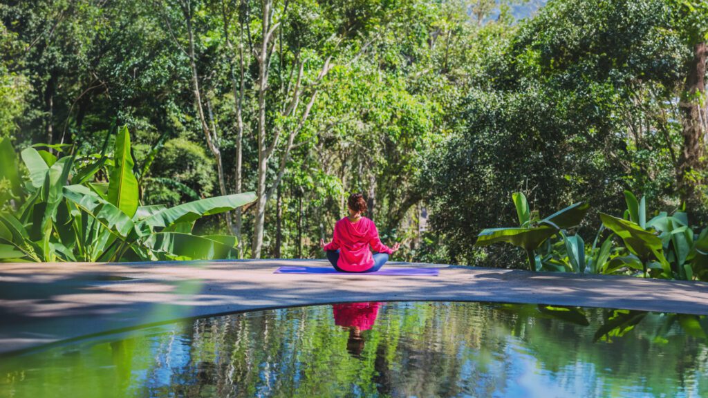 Young woman travel nature she standing exercise at the pool rela